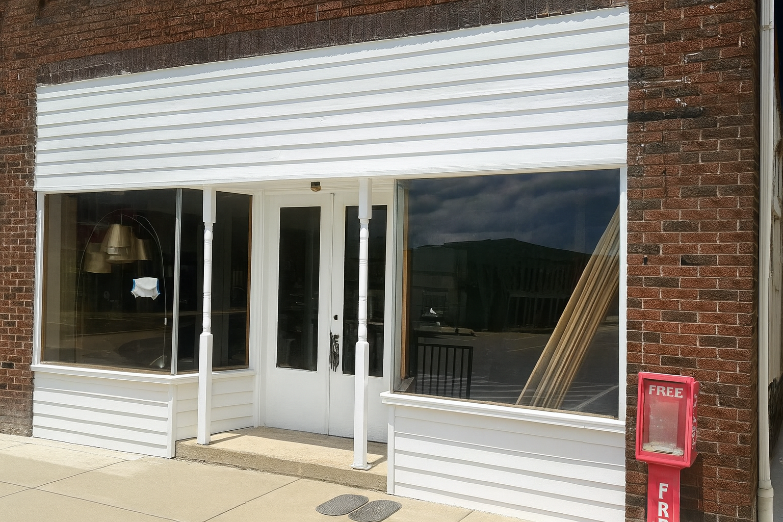 White commercial building front view with large windows, ideal for businesses